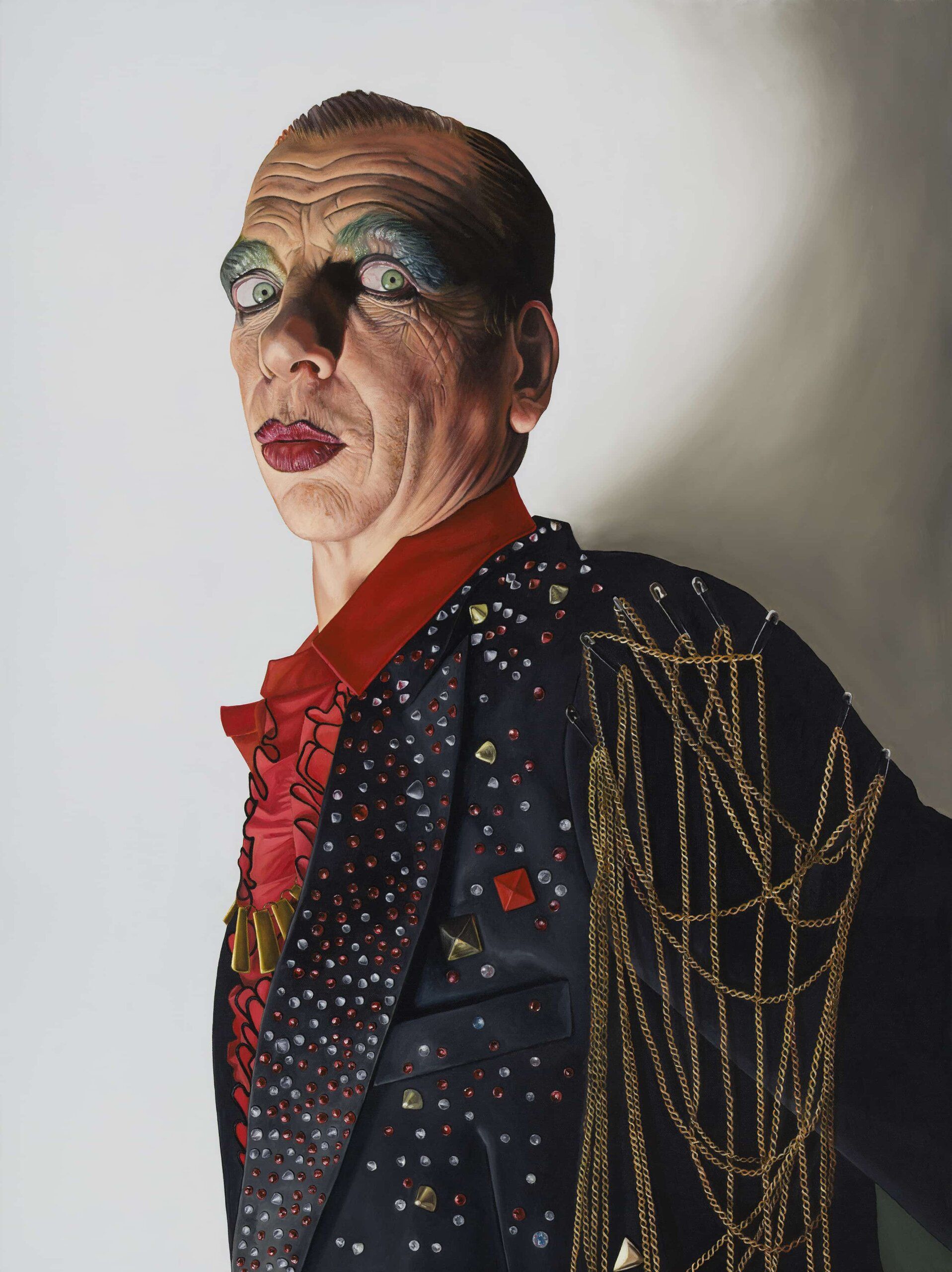 Person with dramatic theatrical makeup, dark jacket with sequins and gold chains.