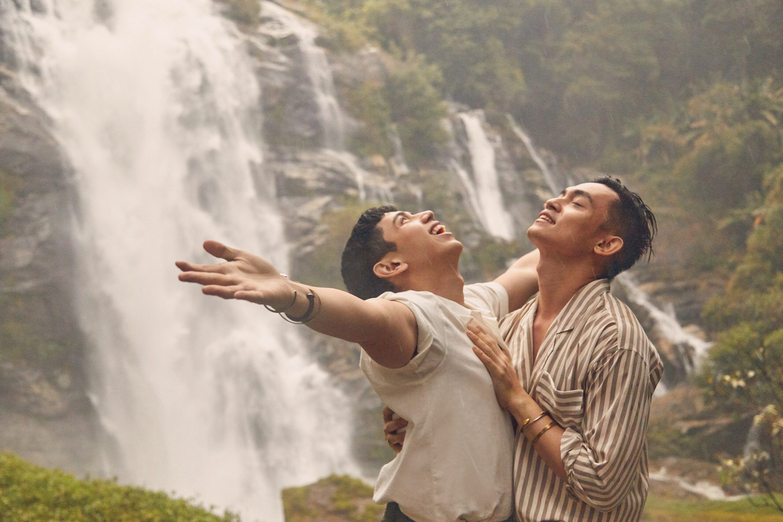 Same-sex couple near a Thai waterfall